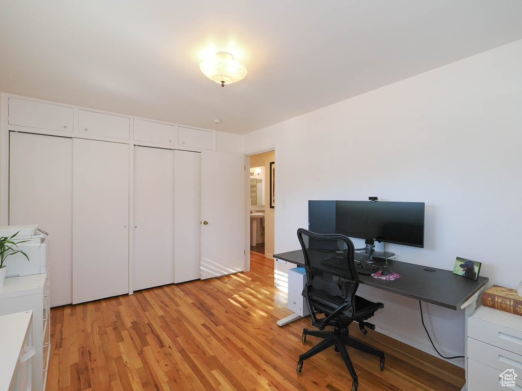 Office area with light hardwood / wood-style floors