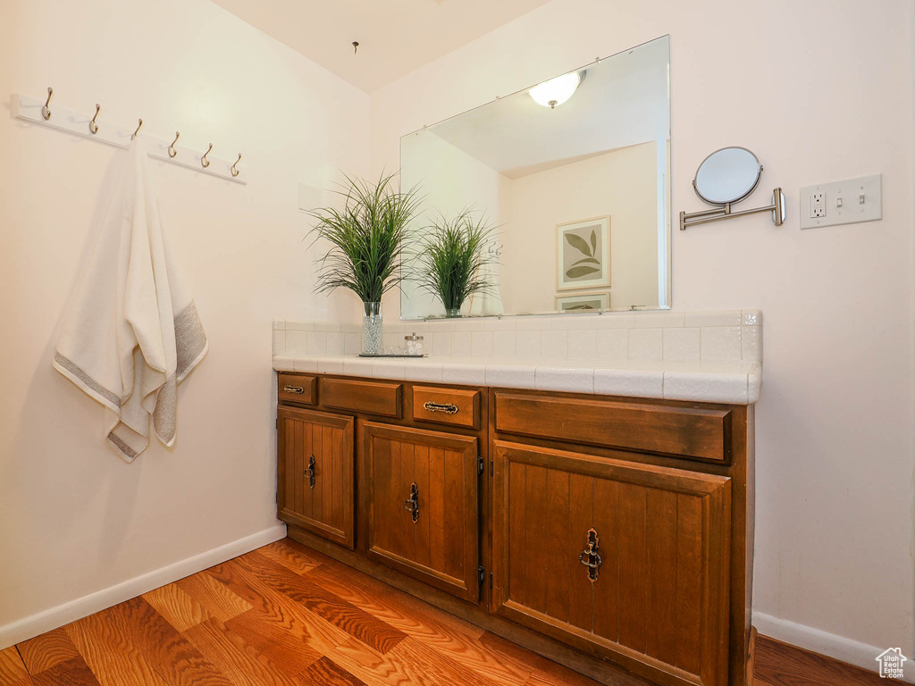 Bathroom with vanity and hardwood / wood-style floors