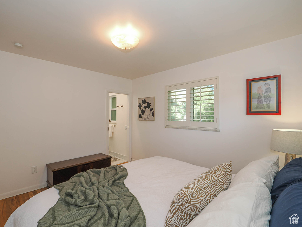 Bedroom with hardwood / wood-style floors