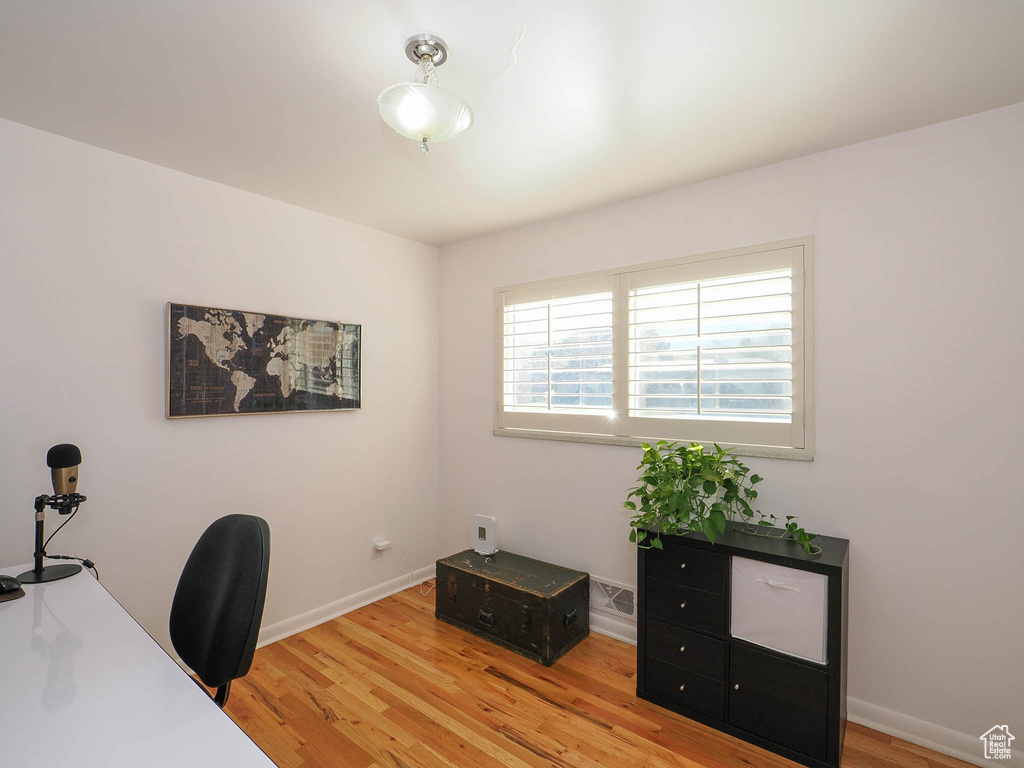 Office area with light hardwood / wood-style flooring