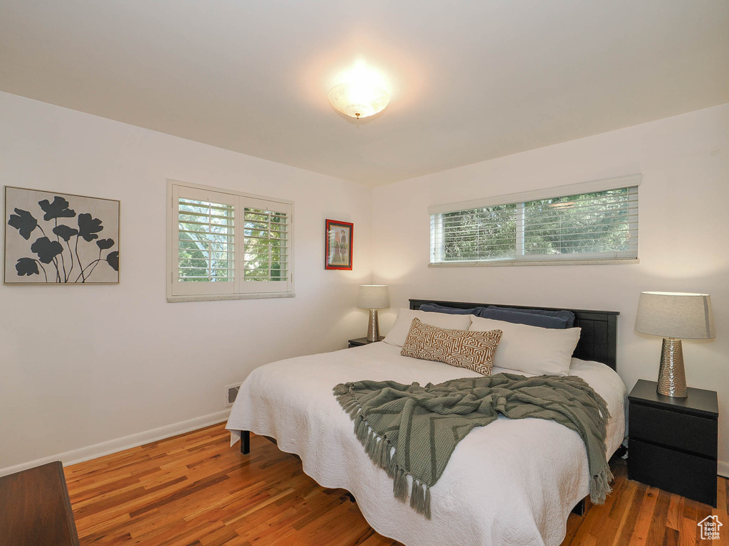 Bedroom with wood-type flooring