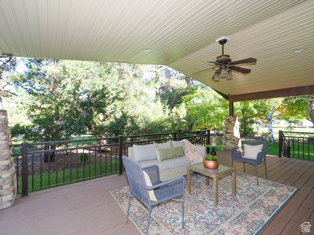 Deck with an outdoor hangout area and ceiling fan