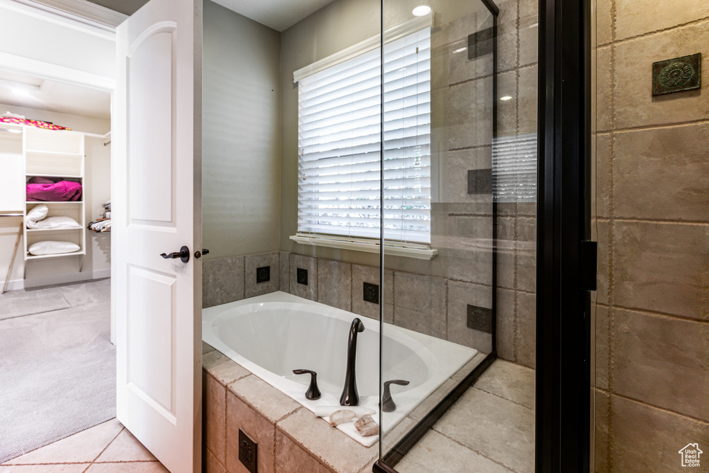 Bathroom featuring separate shower and tub and tile patterned floors