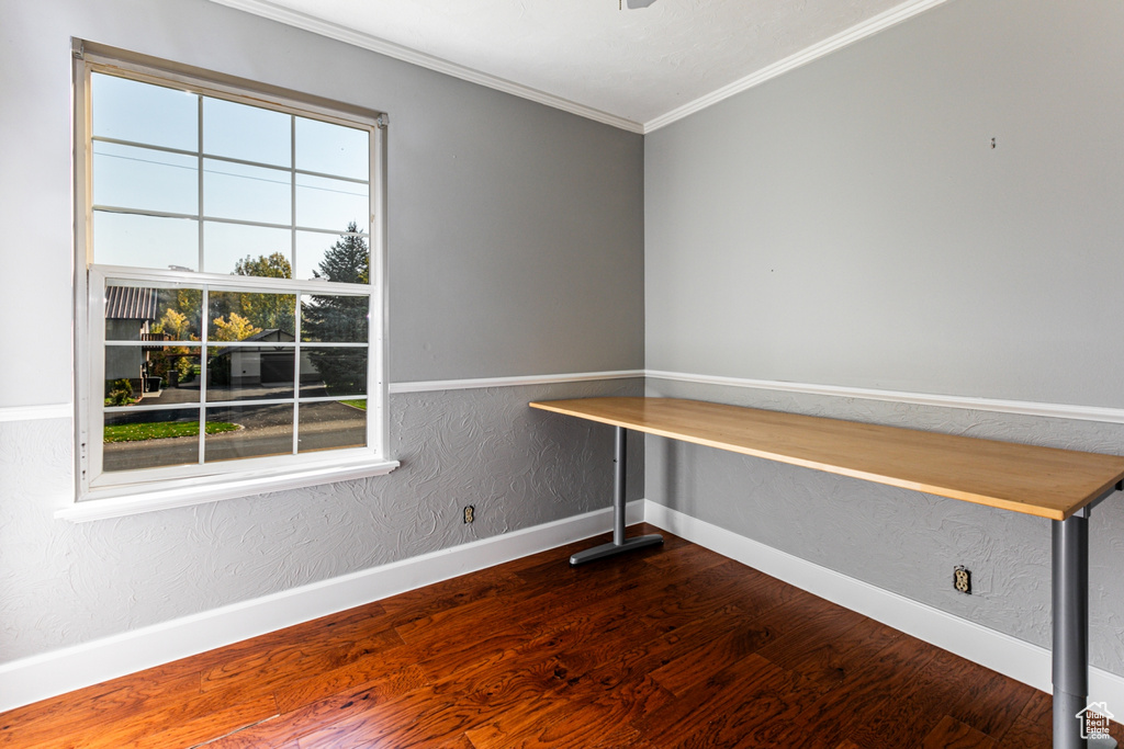 Unfurnished office featuring hardwood / wood-style flooring and ornamental molding