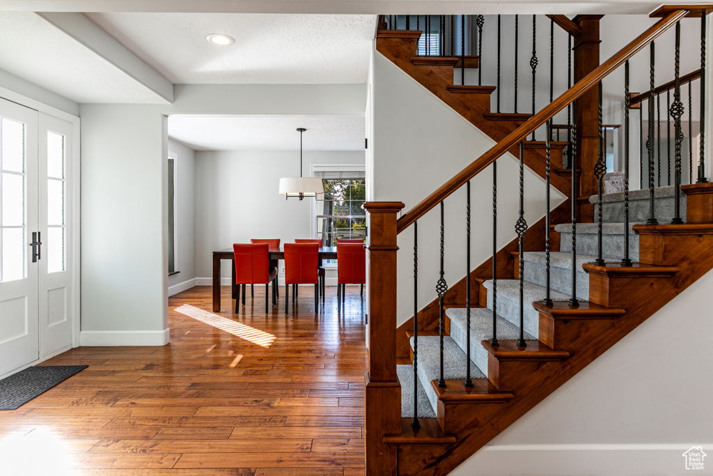 Foyer entrance with french doors and hardwood / wood-style flooring