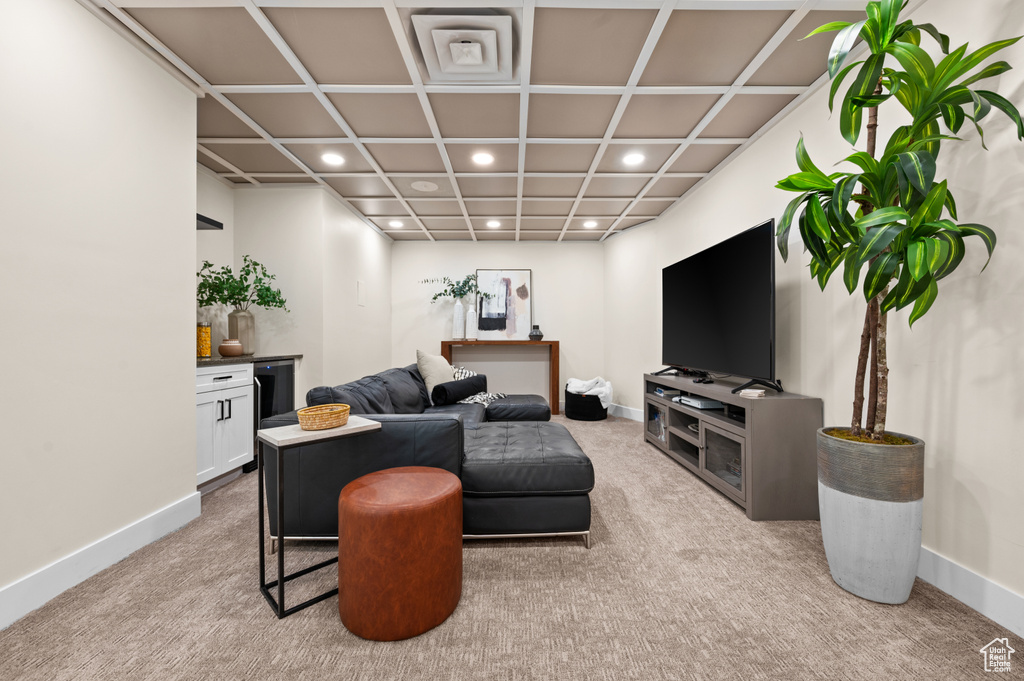 Living room with light carpet and coffered ceiling