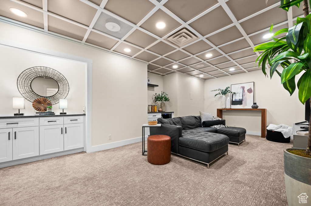 Living room featuring coffered ceiling and light colored carpet