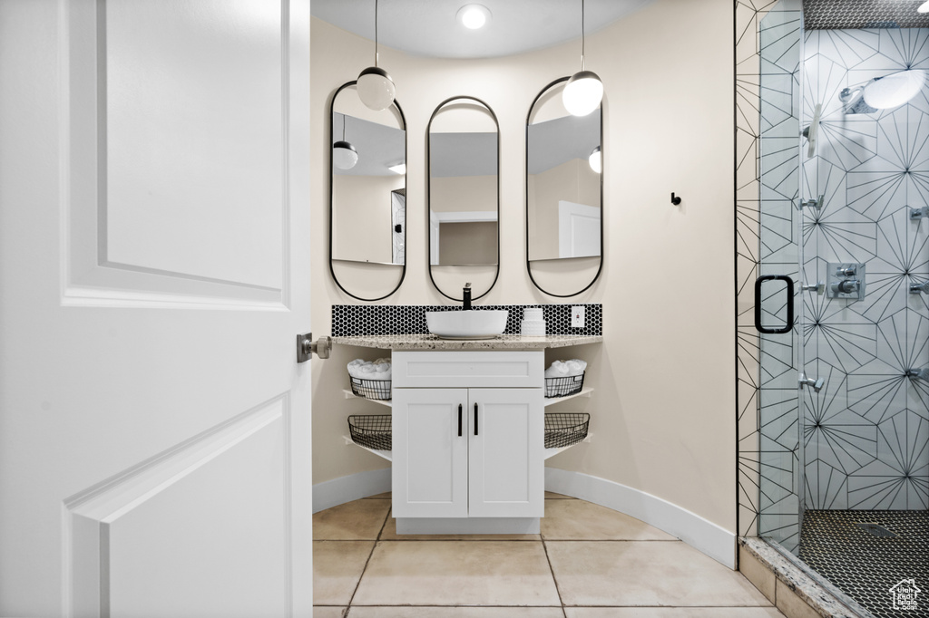 Bathroom with vanity, walk in shower, and tile patterned floors