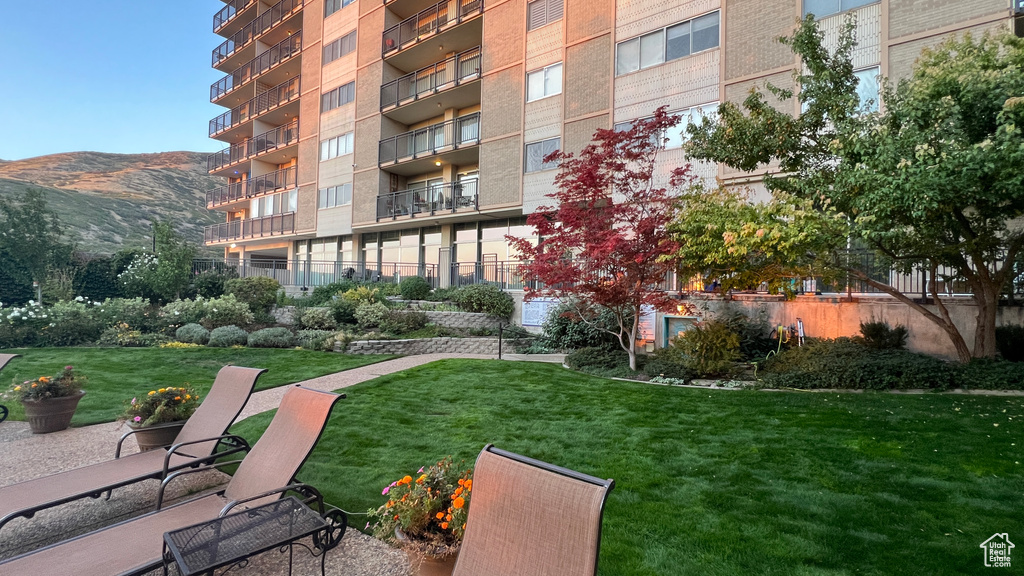 View of property\\\'s community featuring a mountain view and a lawn