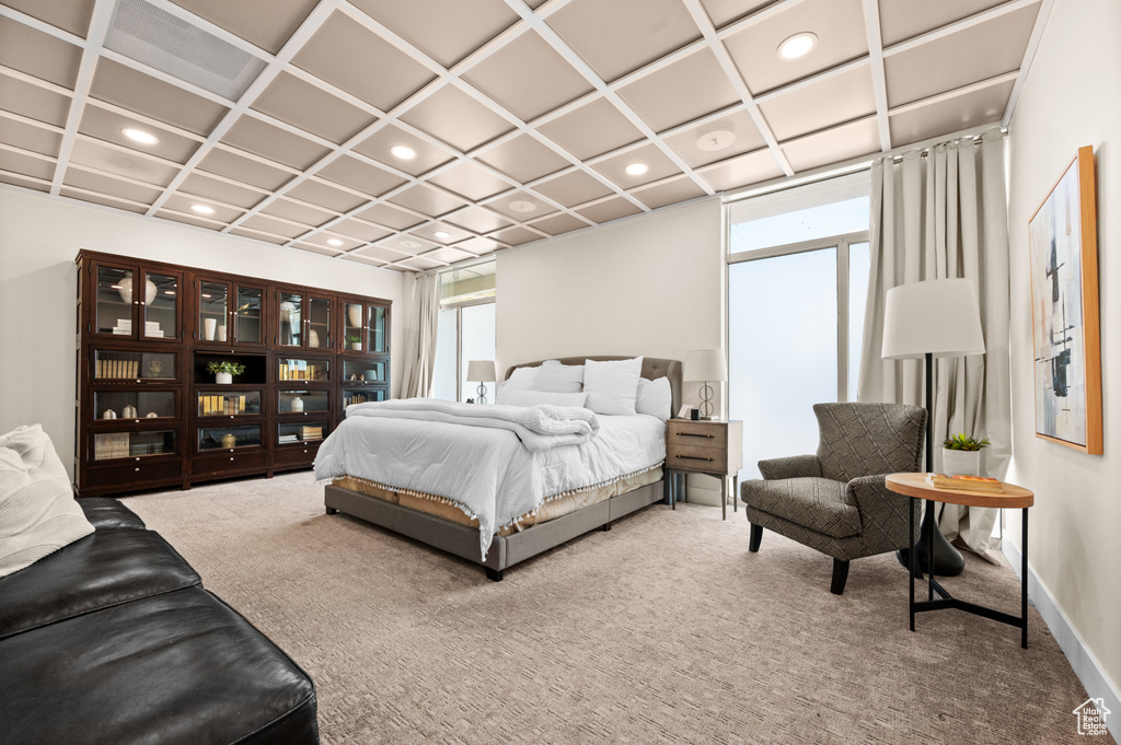 Carpeted bedroom featuring coffered ceiling