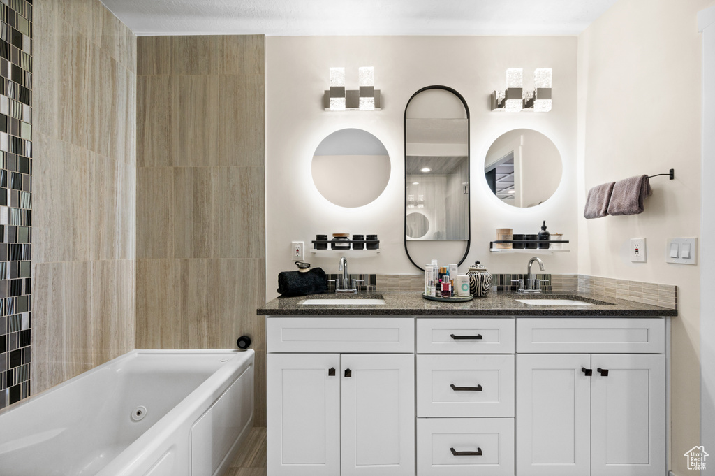 Bathroom featuring a bathtub and vanity