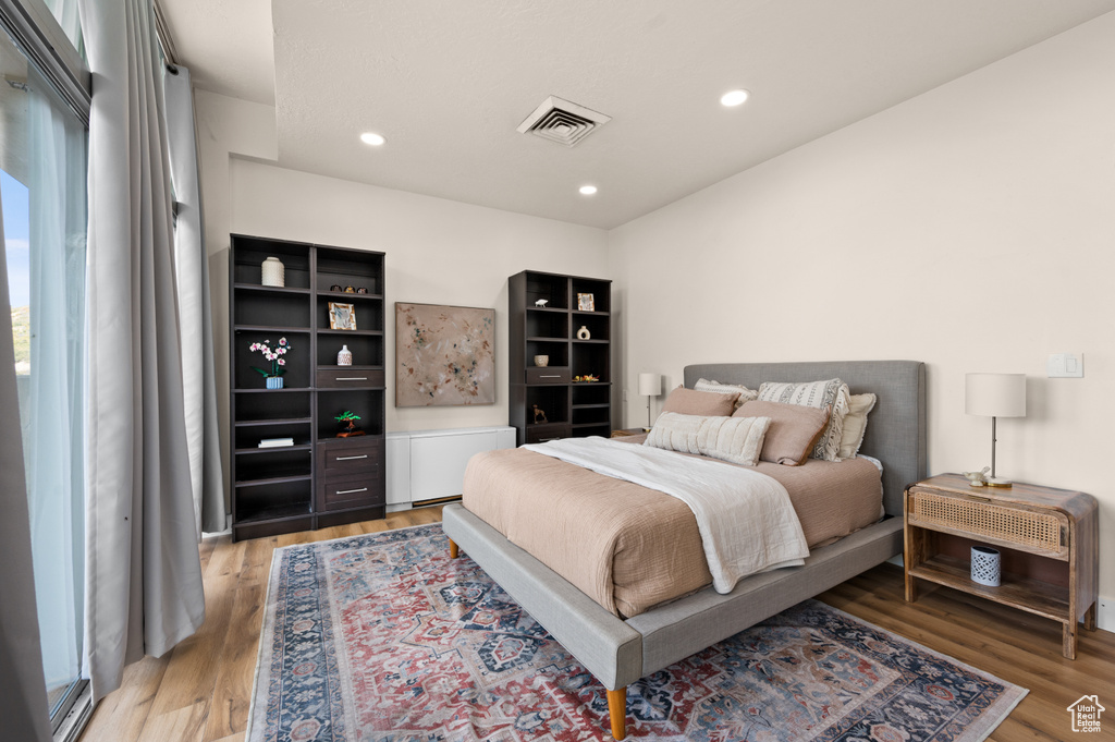 Bedroom with light hardwood / wood-style floors