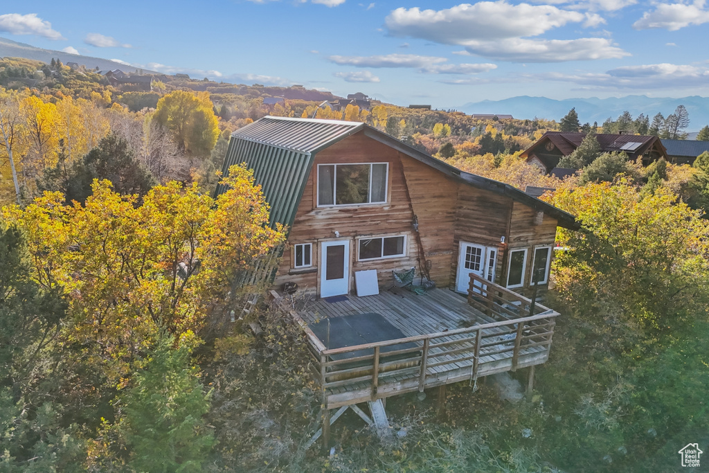 Back of house with a deck with mountain view