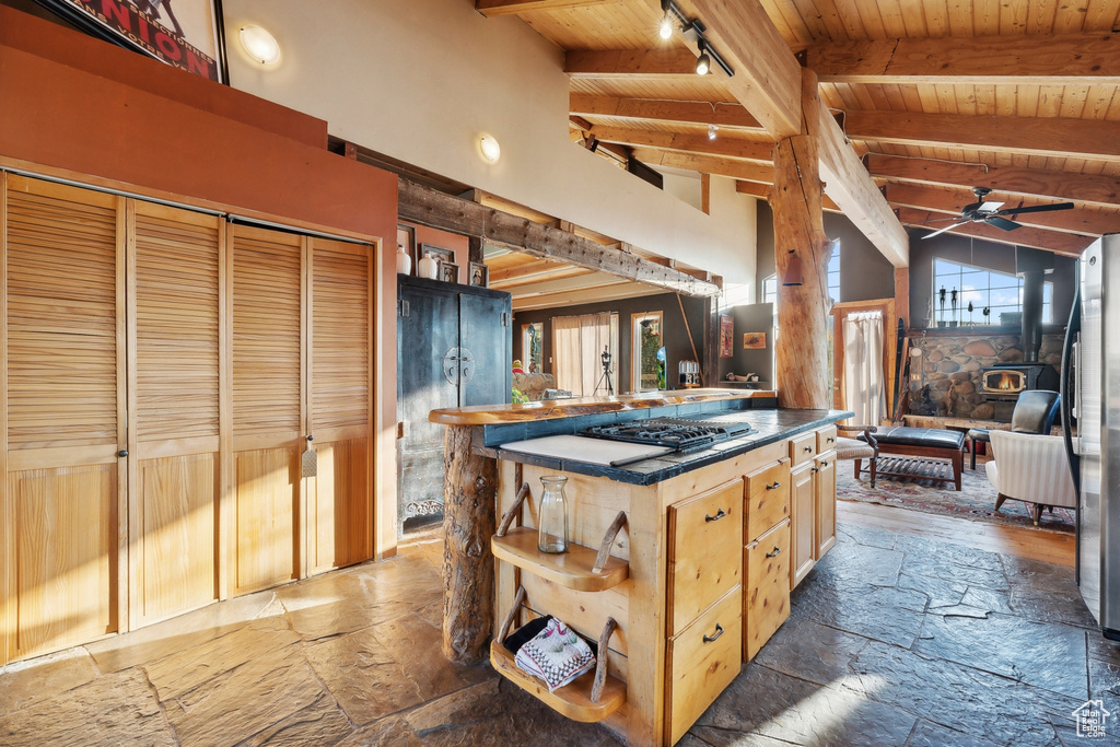 Kitchen with wood ceiling, ceiling fan, beamed ceiling, black gas cooktop, and light brown cabinets