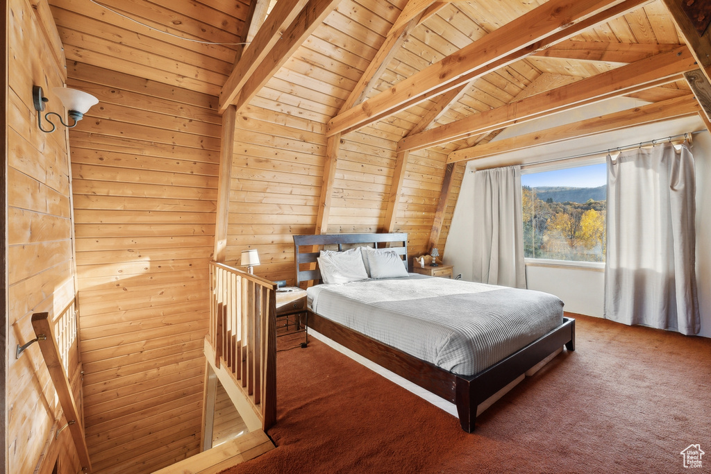 Carpeted bedroom with vaulted ceiling with beams, wood ceiling, and wood walls