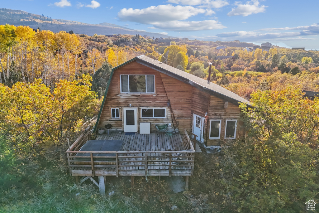 Rear view of house featuring a deck with mountain view