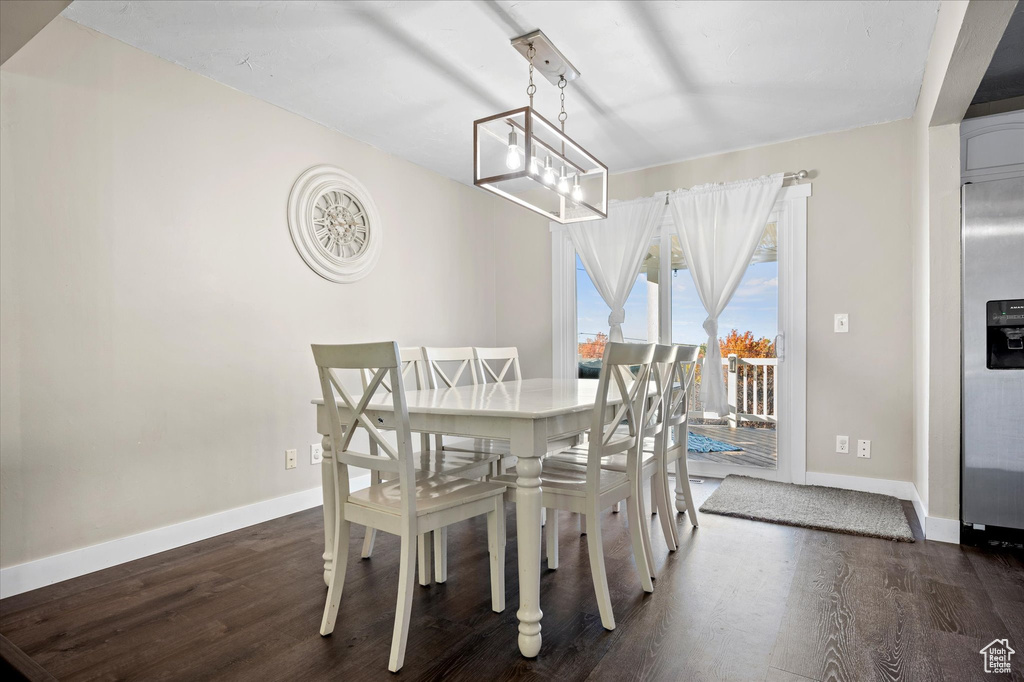 Dining room with dark wood-type flooring