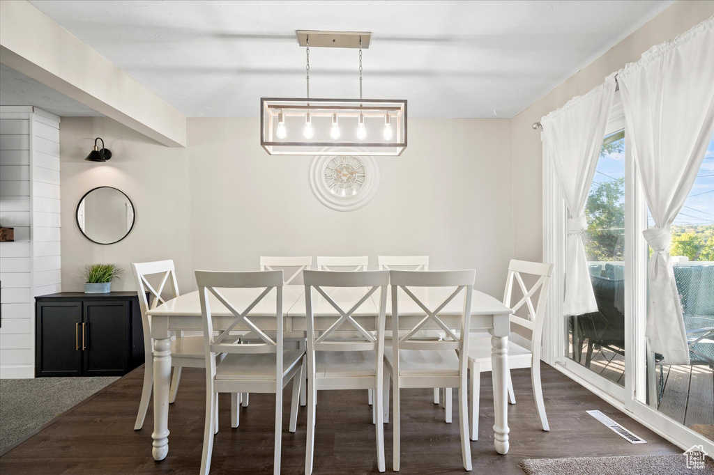 Unfurnished dining area featuring dark hardwood / wood-style flooring