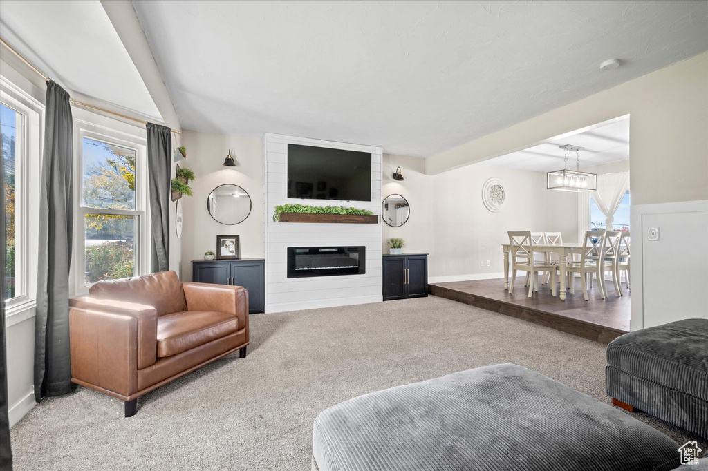 Carpeted living room with a large fireplace