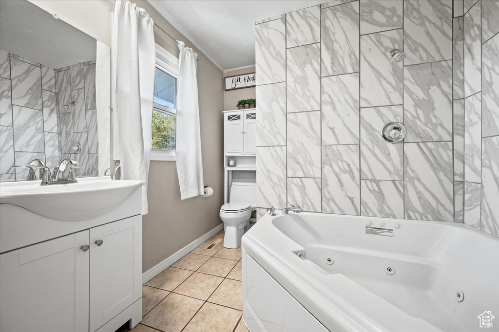 Bathroom featuring toilet, vanity, and tile patterned floors