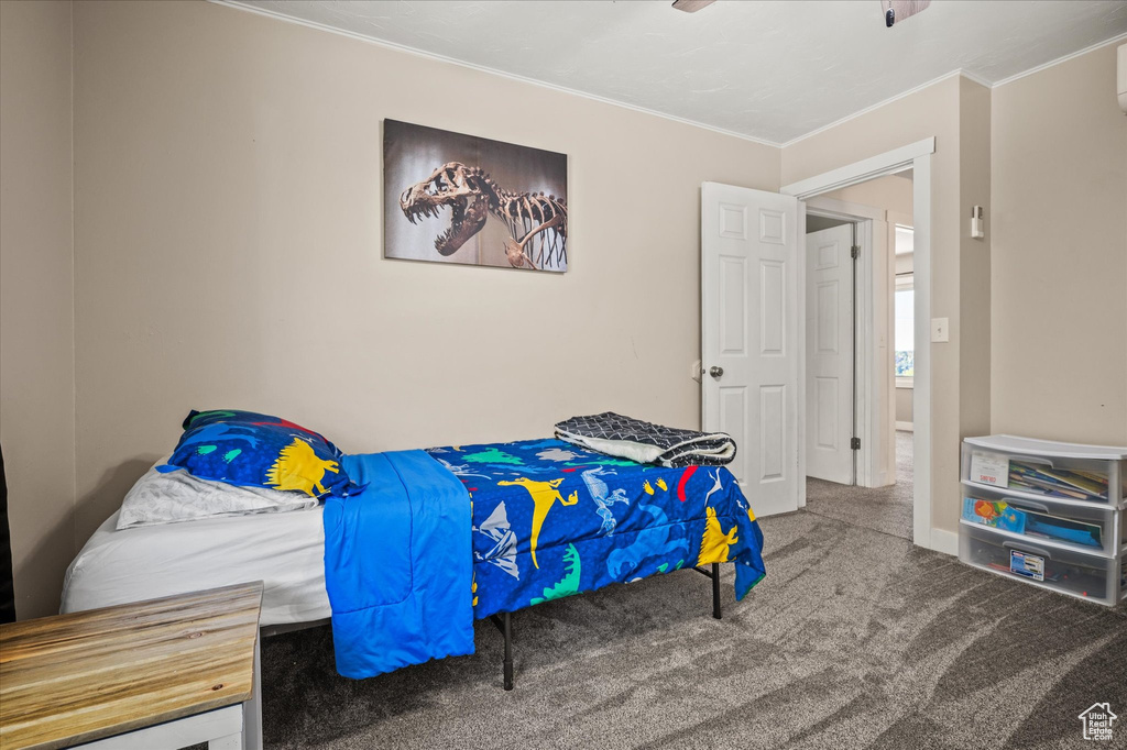 Bedroom with ornamental molding, carpet, and ceiling fan