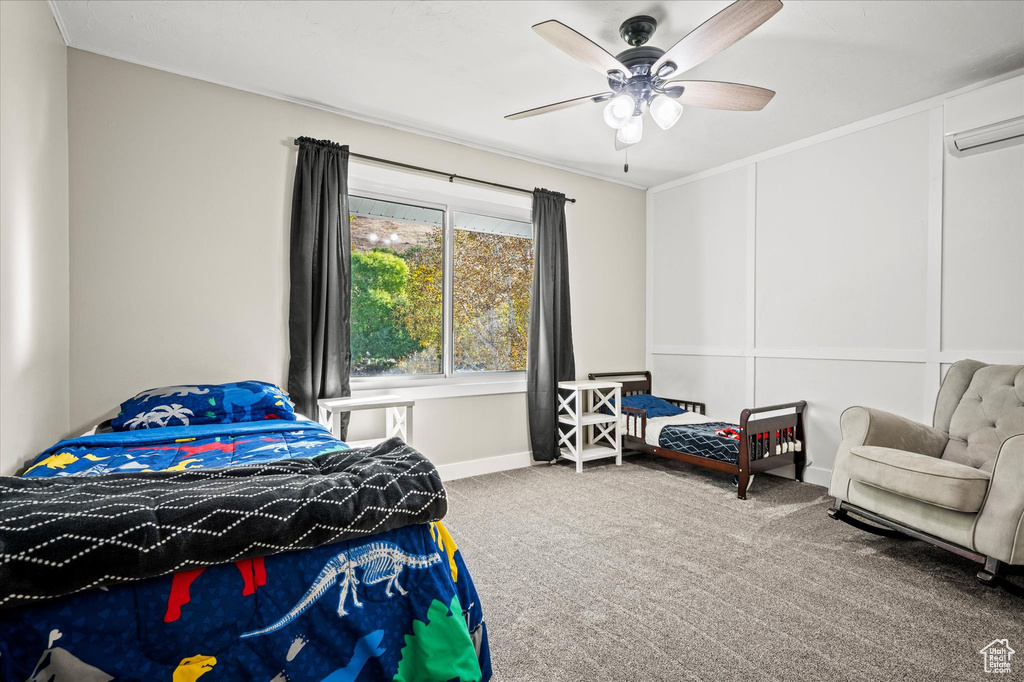 Bedroom with ceiling fan, carpet, and a wall unit AC