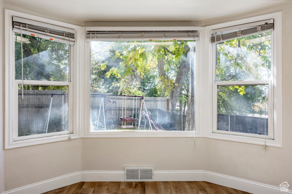 Unfurnished dining area featuring hardwood / wood-style floors