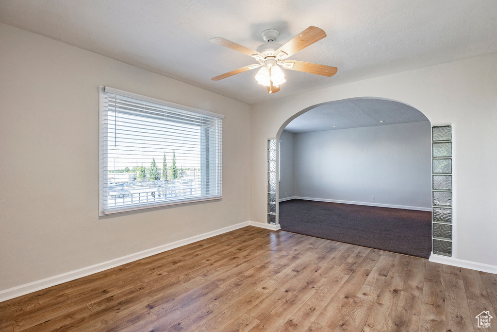 Empty room featuring light hardwood / wood-style floors and ceiling fan