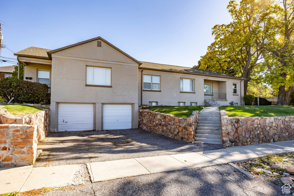 View of front of home featuring a garage and a front lawn