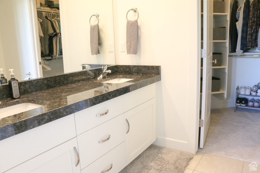 Bathroom with vanity and tile patterned flooring