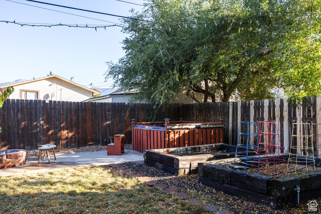 View of yard featuring a patio area and an outdoor fire pit