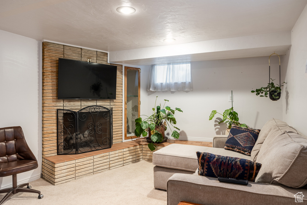 Living room with carpet floors and a brick fireplace