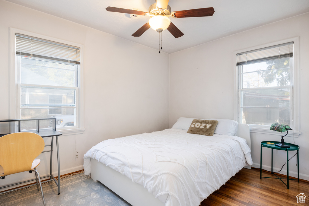 Bedroom with dark wood-type flooring and ceiling fan