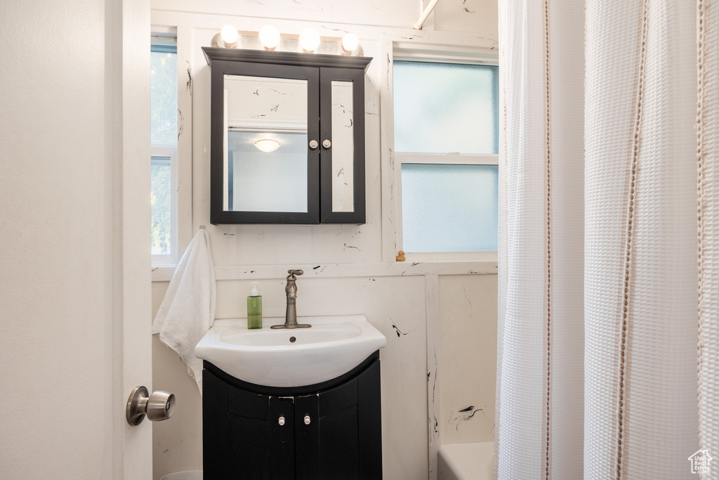 Bathroom featuring vanity and shower / bath combo