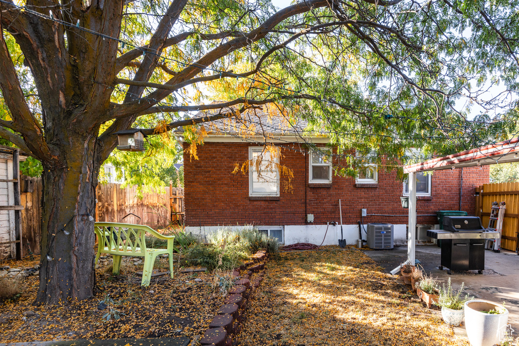 View of side of home with a patio and cooling unit