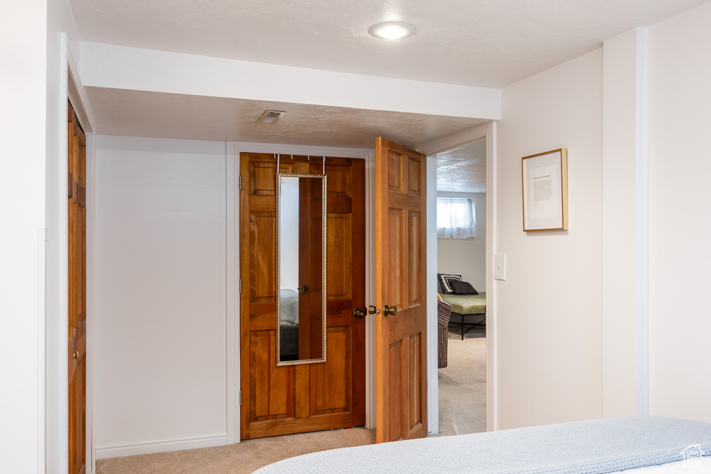 Bedroom with a closet and light carpet