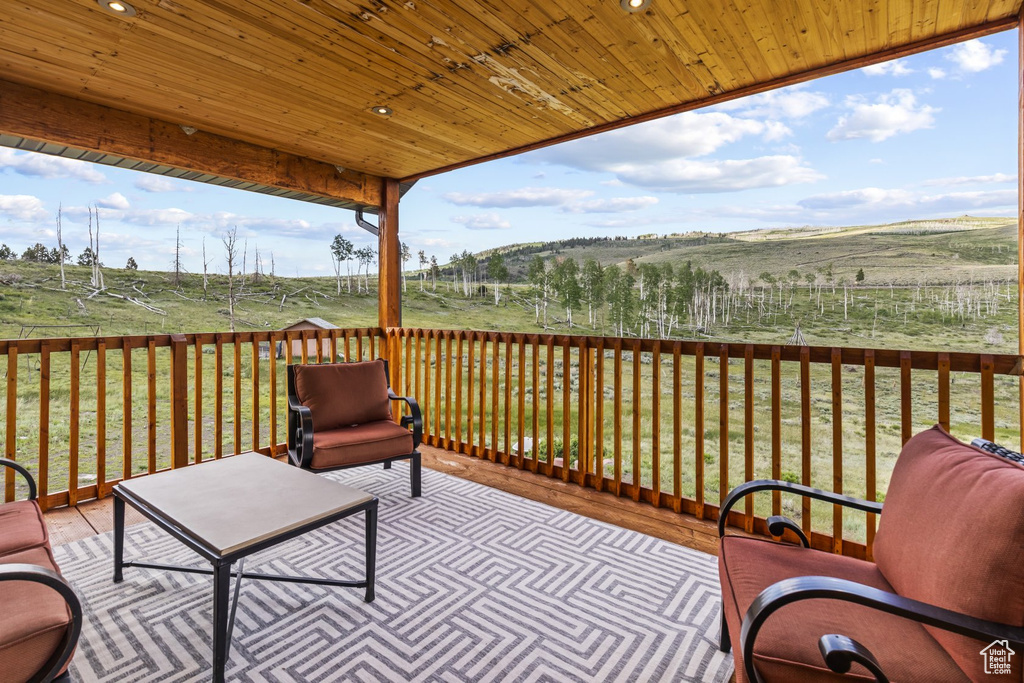 Deck with a lawn and a rural view