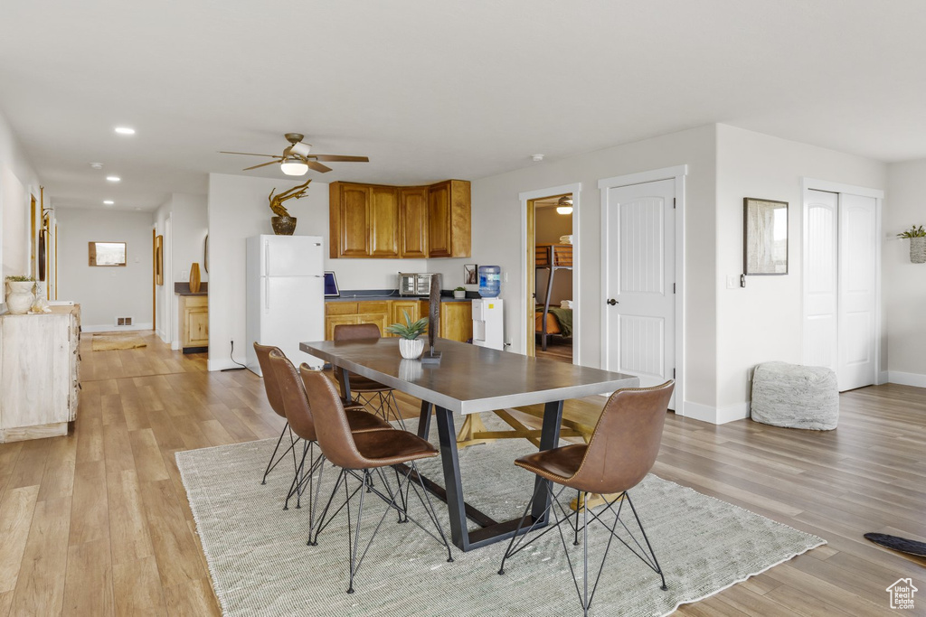 Dining room featuring ceiling fan and light hardwood / wood-style flooring