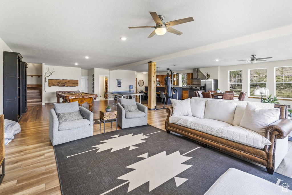 Living room featuring ceiling fan and hardwood / wood-style floors