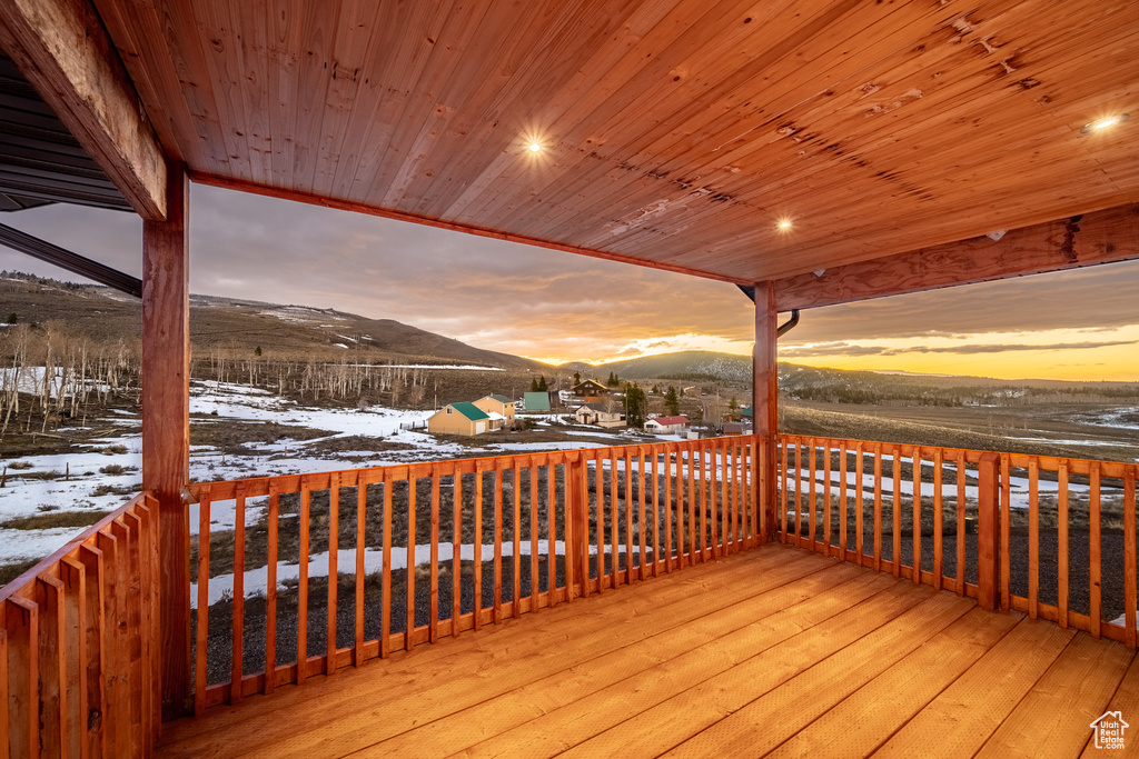 Snow covered deck featuring a mountain view