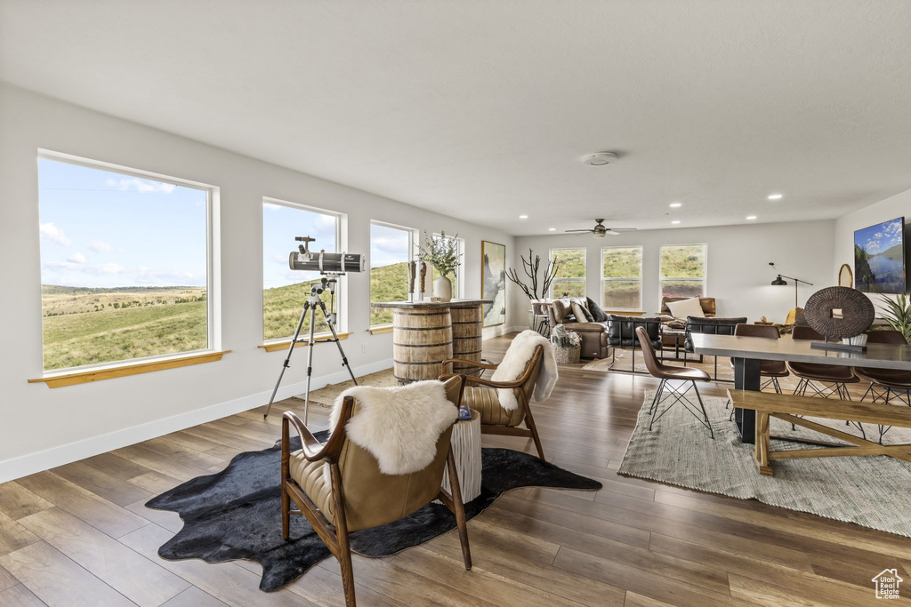 Dining room with ceiling fan and hardwood / wood-style flooring