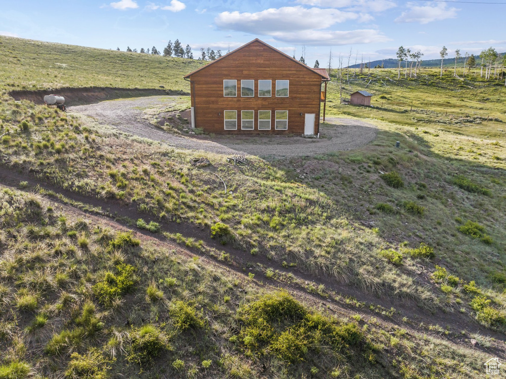 View of side of home with a rural view