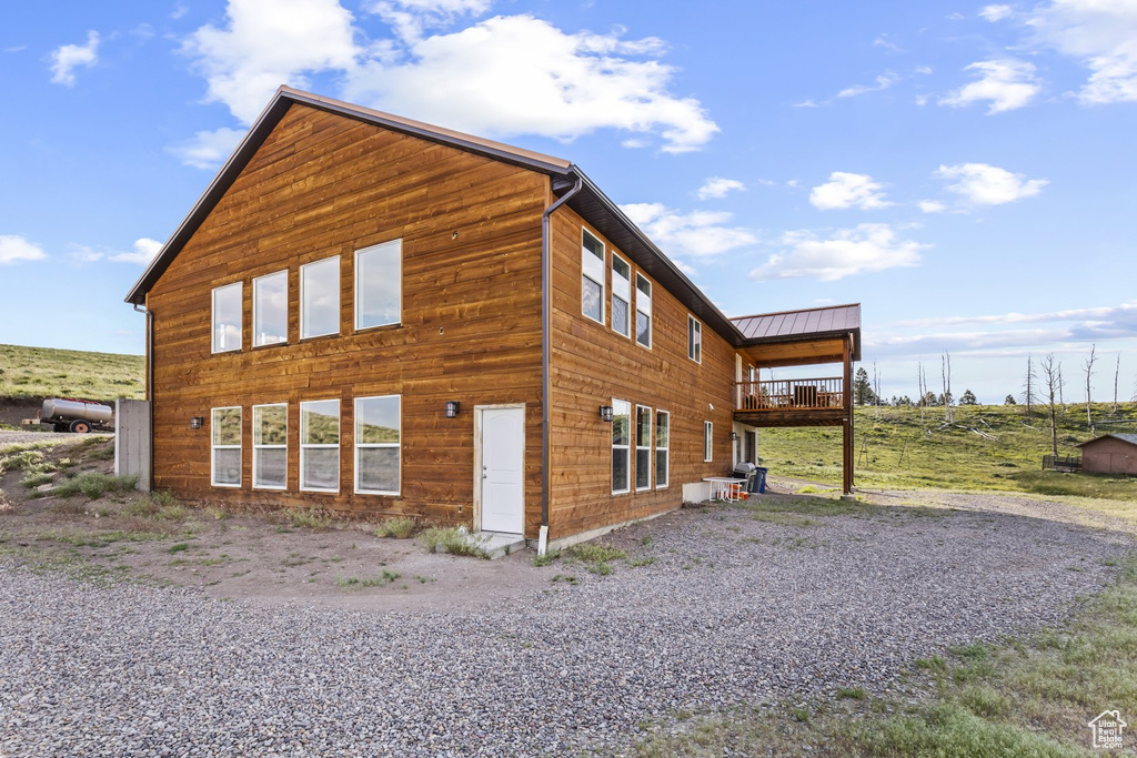 View of side of property featuring a balcony