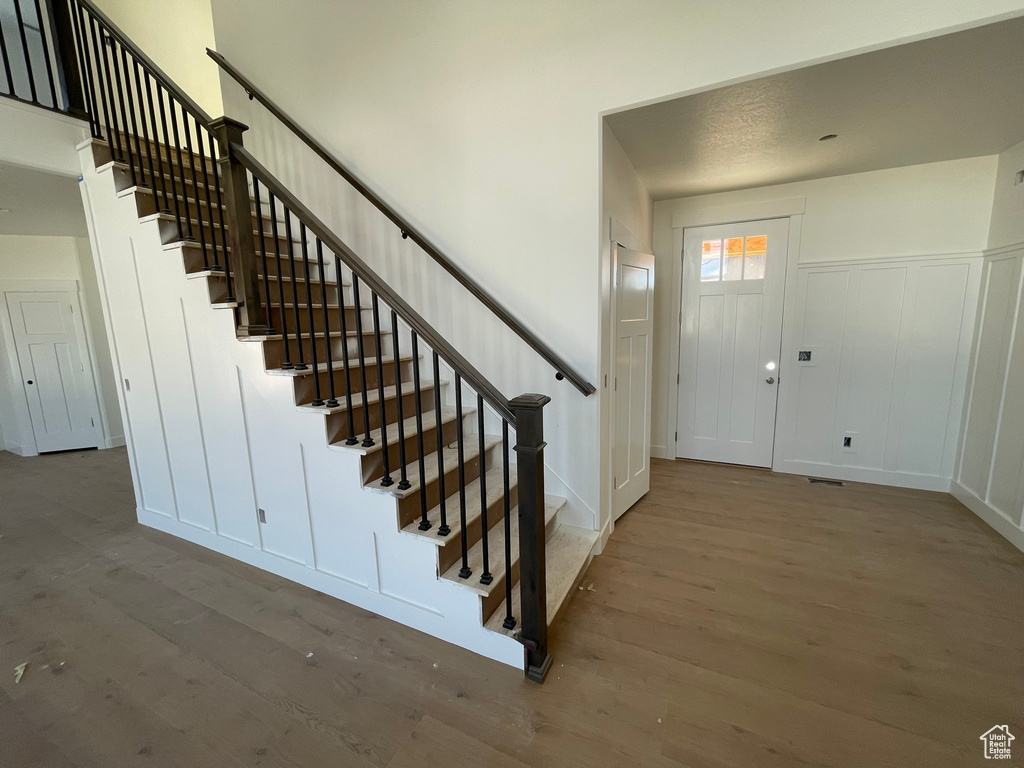 Entrance foyer with wood-type flooring