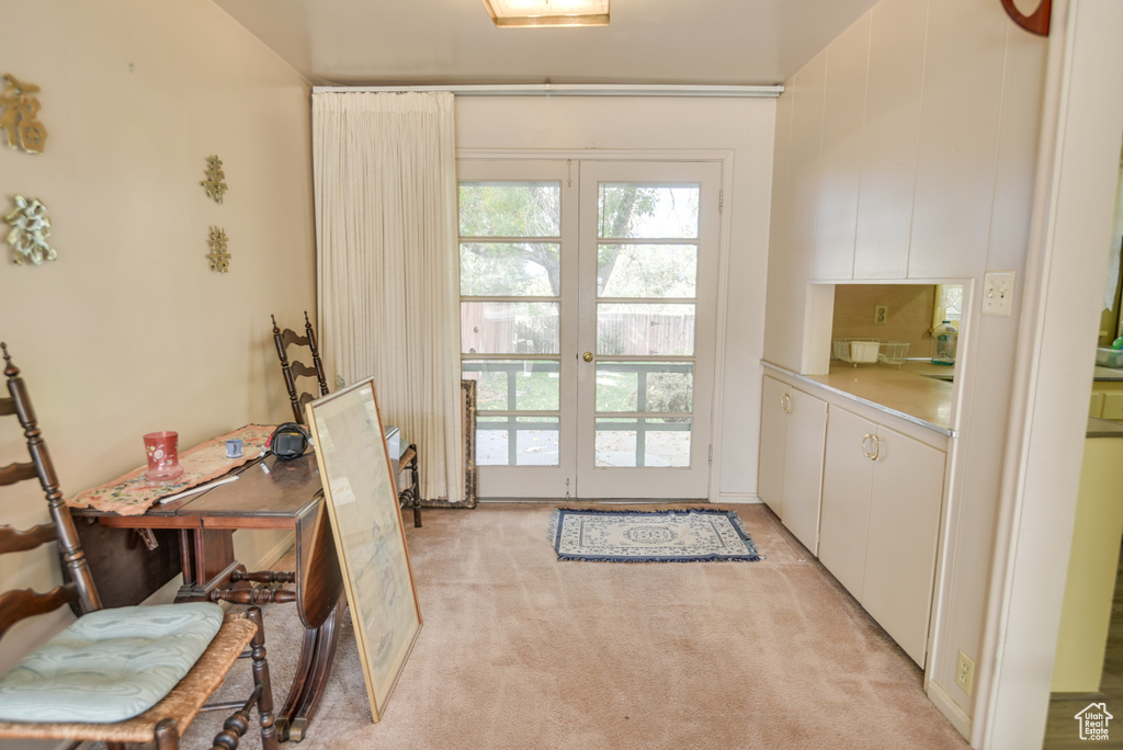 Doorway featuring french doors and light colored carpet