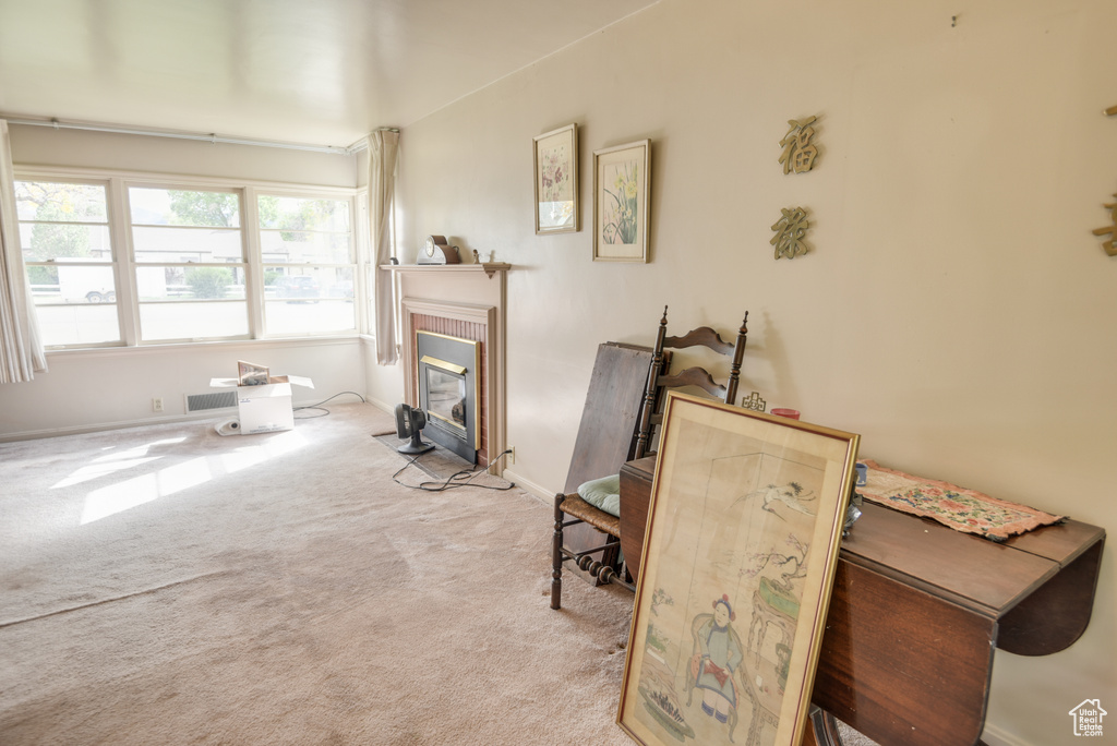 Sitting room featuring light carpet and a tile fireplace