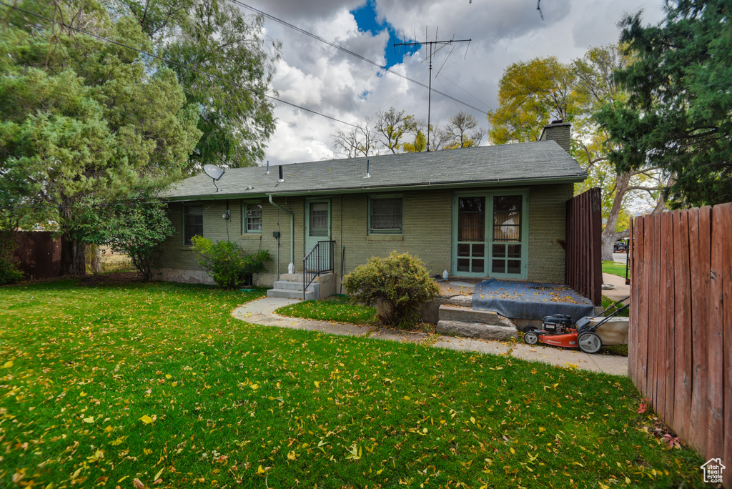 Back of house featuring a lawn