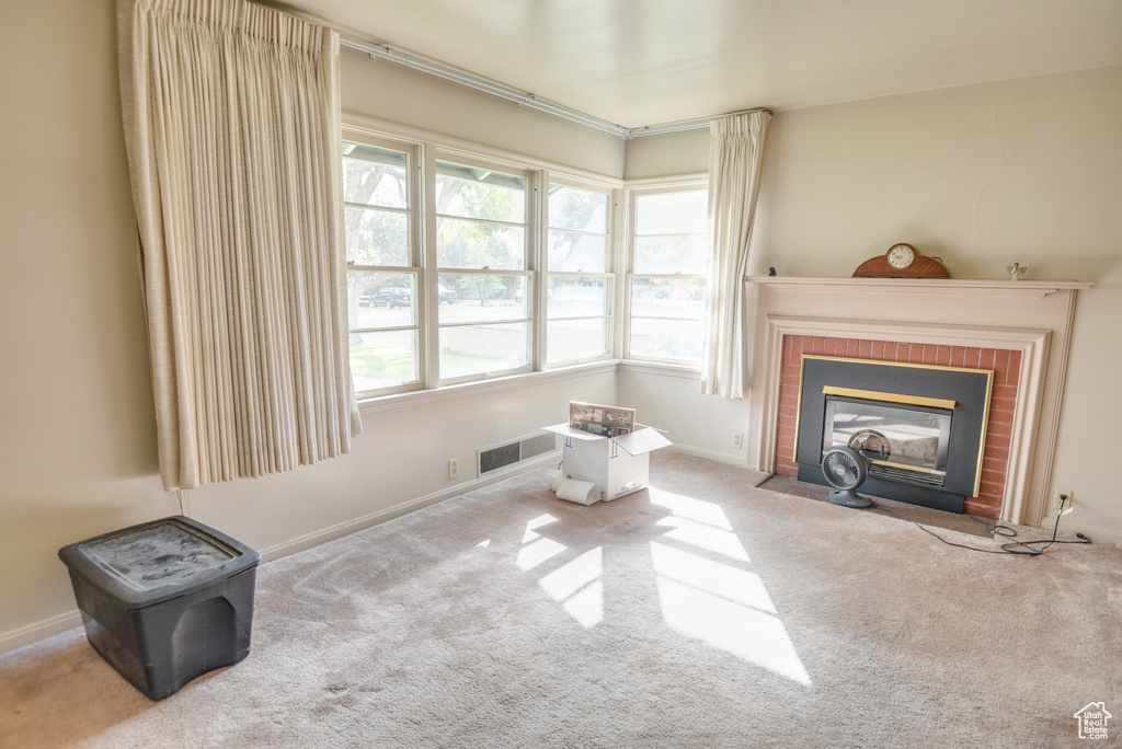 Living room featuring carpet flooring and a fireplace