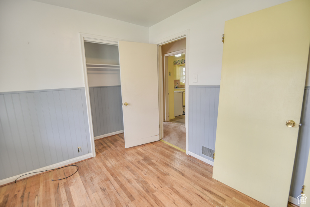 Unfurnished bedroom featuring light hardwood / wood-style flooring and a closet
