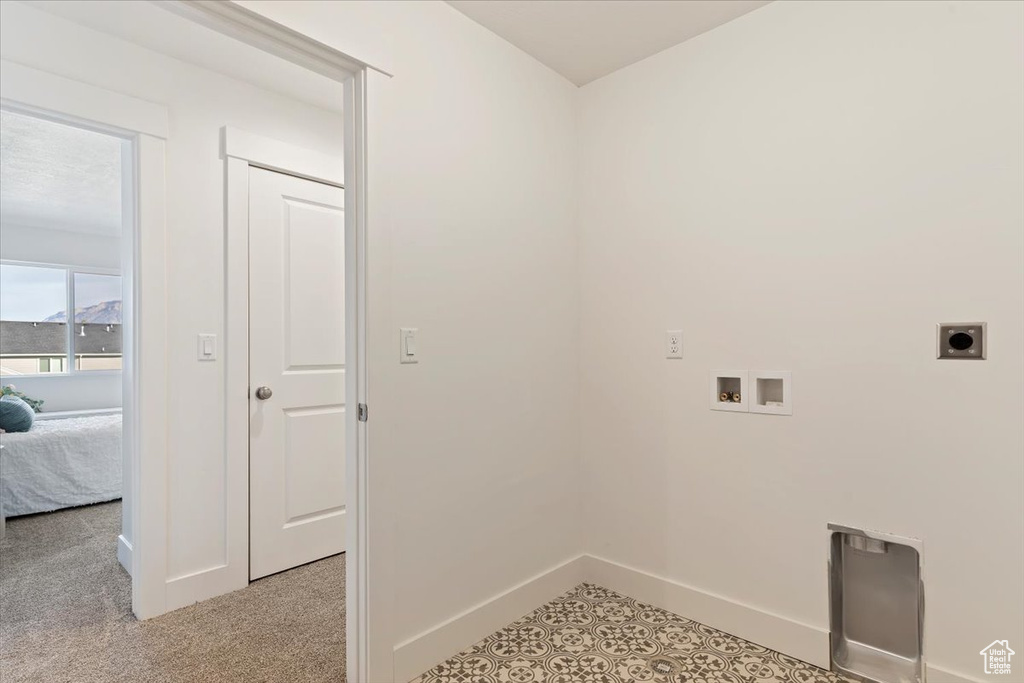 Laundry room featuring light carpet, hookup for an electric dryer, and washer hookup